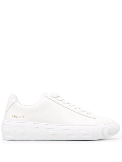 Shop Versace Greca Embossed Sneakers In White