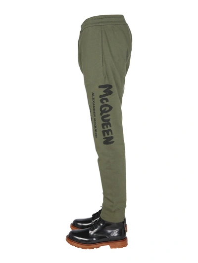 Shop Alexander Mcqueen Jogging Pants With Graffiti Logo In Brown
