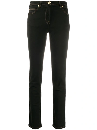 Shop Versace Medusa Motif Skinny Jeans In Black