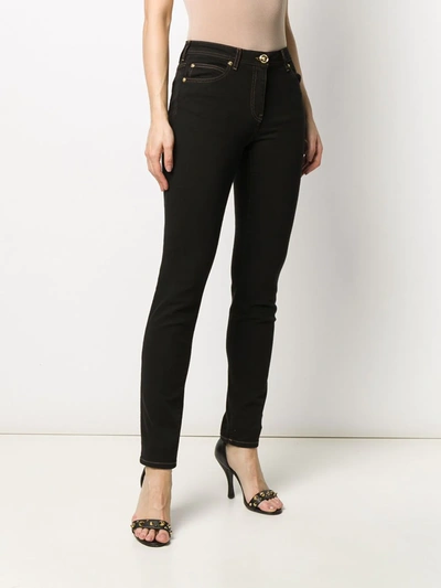 Shop Versace Medusa Motif Skinny Jeans In Black