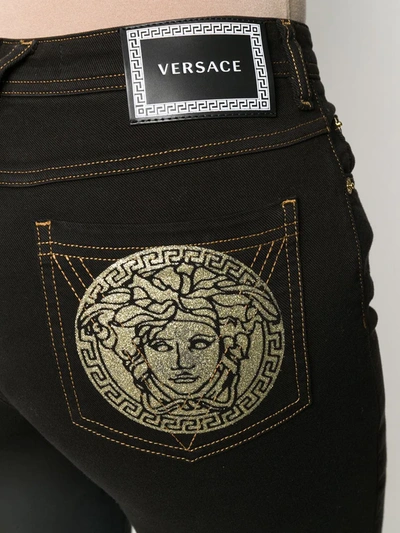Shop Versace Medusa Motif Skinny Jeans In Black