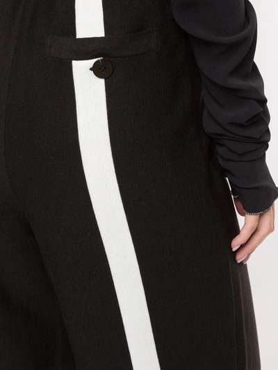 Shop Akira Naka Rear Stripe Flared Trousers In Black