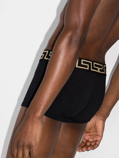 Shop Versace Logo-waistband Set Of Three Boxer Shorts In Black