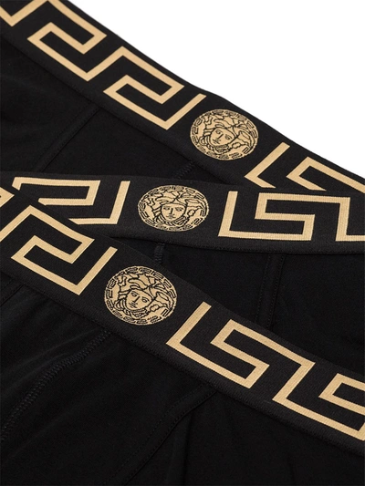 Shop Versace Logo-waistband Set Of Three Boxer Shorts In Black