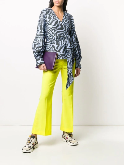 Shop Msgm Low-rise Flared Trousers In Yellow