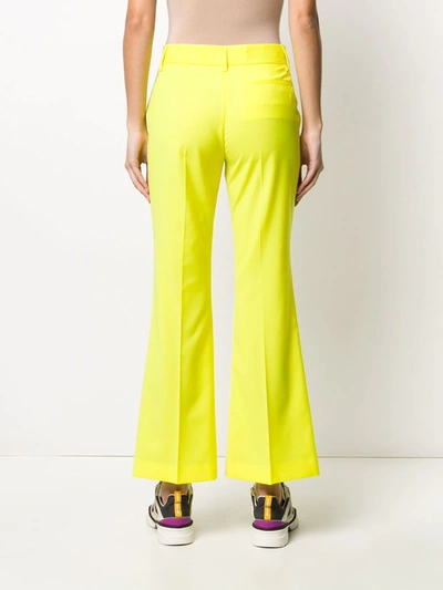 Shop Msgm Low-rise Flared Trousers In Yellow