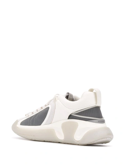 Shop Balmain B-runner Asymmetrical Sneakers In White