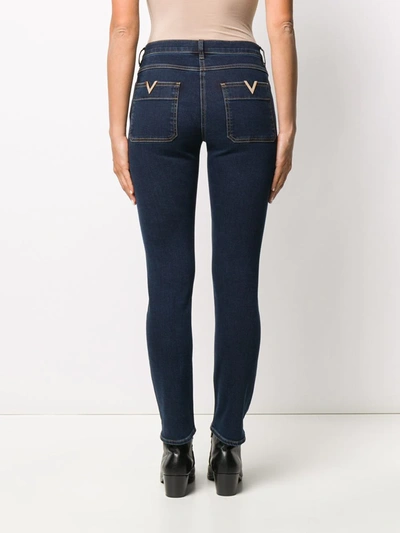 Shop Valentino V-gold Plaque Skinny Jeans In Blue