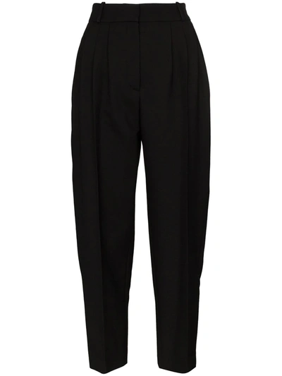 Shop Alexander Mcqueen Tapered Pleated Trousers In Black