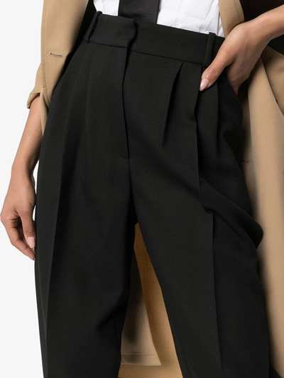 Shop Alexander Mcqueen Tapered Pleated Trousers In Black