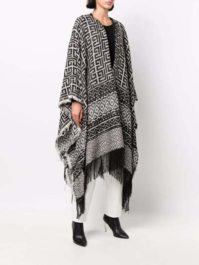 Shop Balmain Maxi Monogram Fringed Cape In Schwarz