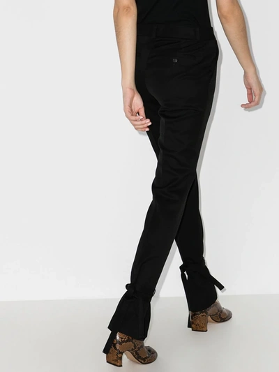 Shop Jw Anderson Tie Hem Slim Fit Trousers In Black