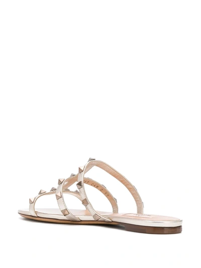 Shop Valentino Rockstud T-strap Sandals In Gold