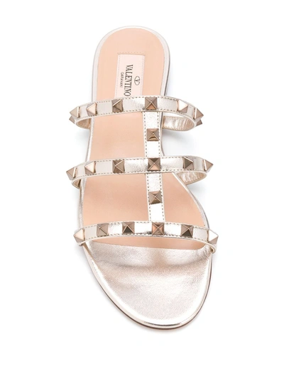 Shop Valentino Rockstud T-strap Sandals In Gold