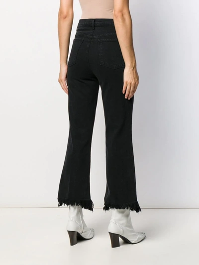 Shop J Brand Distressed Flared Jeans In Black