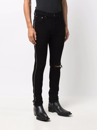 Shop Amiri Ripped-detail Jeans In Black