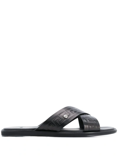 Shop Versace Embossed Greca Crossover Strap Sandals In Black