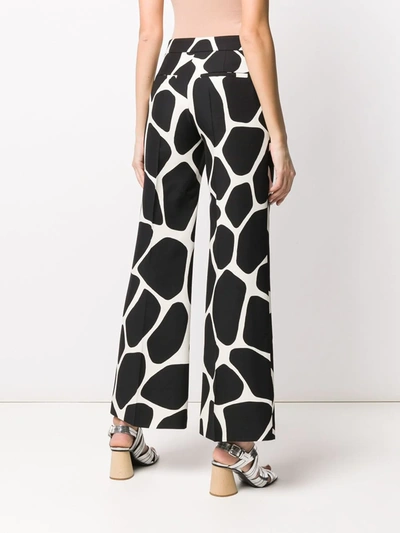 Shop Valentino Giraffe Print Palazzo Trousers In Black