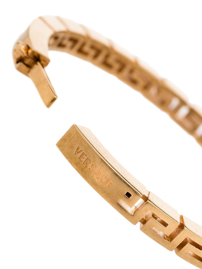 Shop Versace Greca Bangle Bracelet In Gold