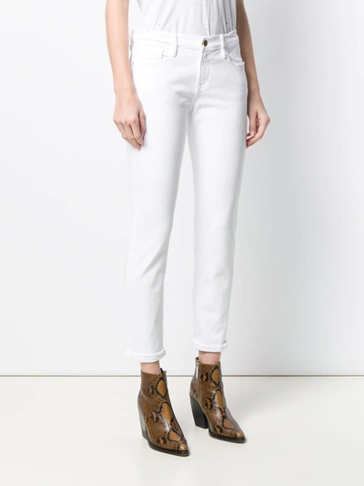 Shop Frame Le Garcon Mid-rise Jeans In White