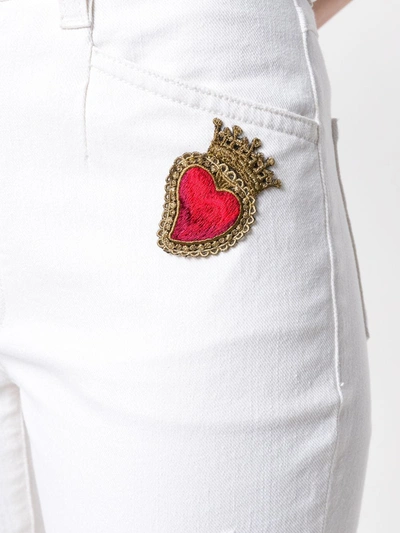 Shop Dolce & Gabbana Sacred Heart Patch Flared Jeans In White
