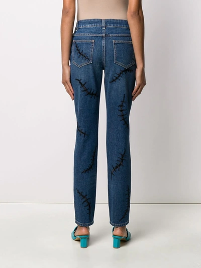 Shop Moschino Embroidered Stitch Mid-rise Jeans In Blue