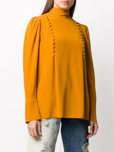 Shop Givenchy Button-embellished High-neck Blouse In Orange