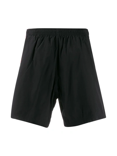 Shop Alexander Mcqueen Side Tape Swim Shorts In Black