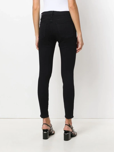 Shop Frame High Rise Skinny Jeans In Black