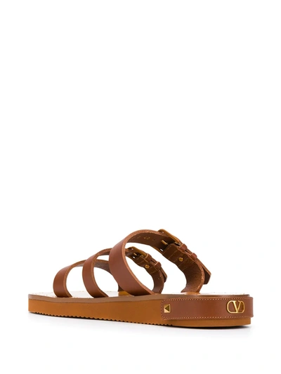 Shop Valentino Rockstud Slide Sandals In Brown
