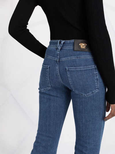 Shop Versace Logo-patch Cropped Jeans In Blue