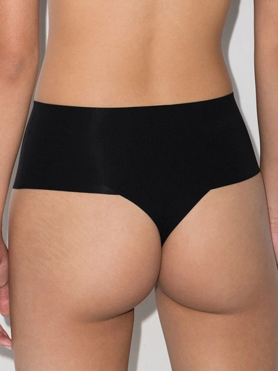Shop Spanx Undie-tectable Mid-rise Thong In Black