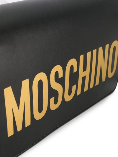 Shop Moschino Logo Flap Shoulder Bag In Black