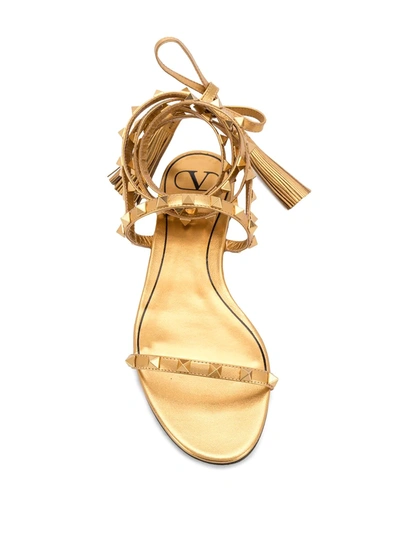 Shop Valentino Rockstud Flat Sandals In Gold