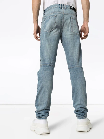 DISTRESSED TAPERED SLIM LEG JEANS