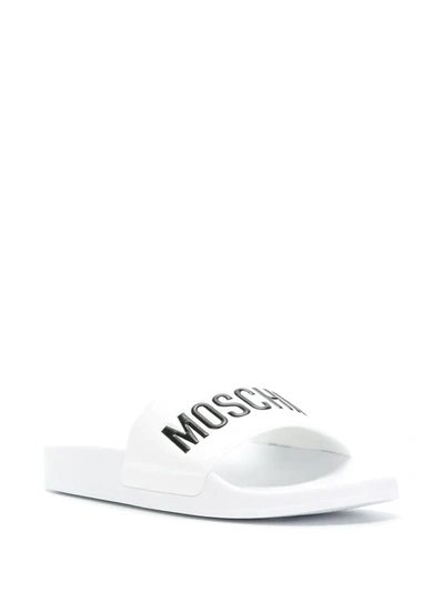 Shop Moschino Logo Print Sliders In White