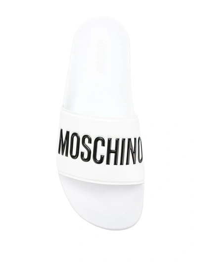 Shop Moschino Logo Print Sliders In White