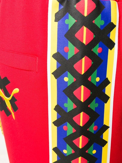 Shop Puma Logo Print Track Pants In Red