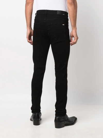 Shop Amiri Logo-plaque Skinny Jeans In Schwarz