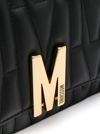Shop Moschino Quilted M Motif Crossbody Bag In Black