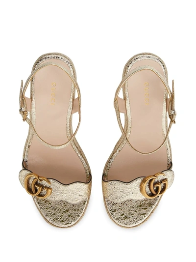 Shop Gucci Gg Buckle Wedge Sandals In Gold