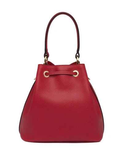Shop Prada Triangle Patch Bucket Bag In Red