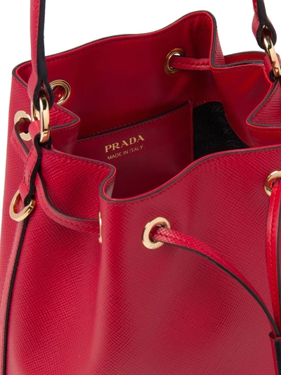 Shop Prada Triangle Patch Bucket Bag In Red