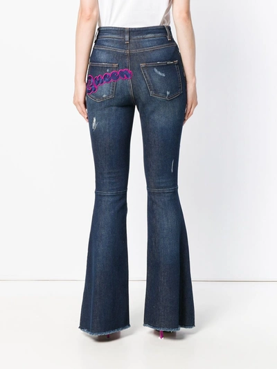 Shop Dolce & Gabbana Ripped Detail Bootcut Jeans In Blue