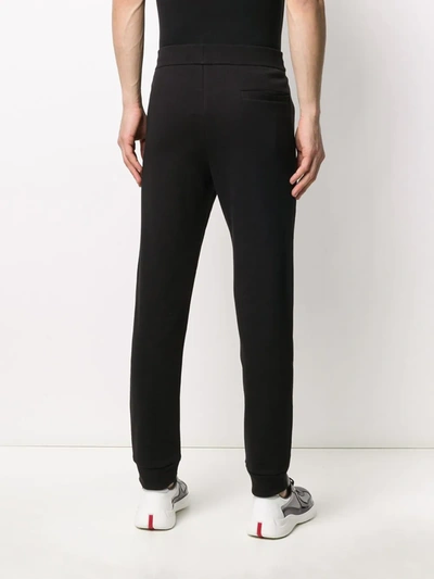 Shop Armani Exchange Logo Embroidered Track Pants In Black