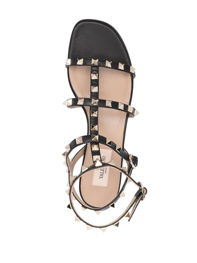 Shop Valentino Rockstud Ankle-strap Flat Sandals In Black