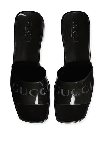 Shop Gucci Logo Embossed Sandals In Black