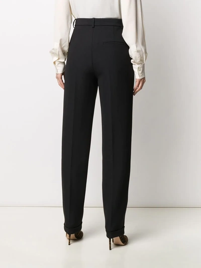 Shop Victoria Beckham Pleated Front Tapered Trousers In Black