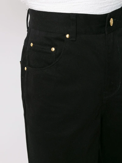 Shop Amapô Flared Jeans In Black