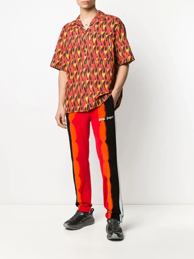 Shop Palm Angels Tie-dye Print Track Pants In Red